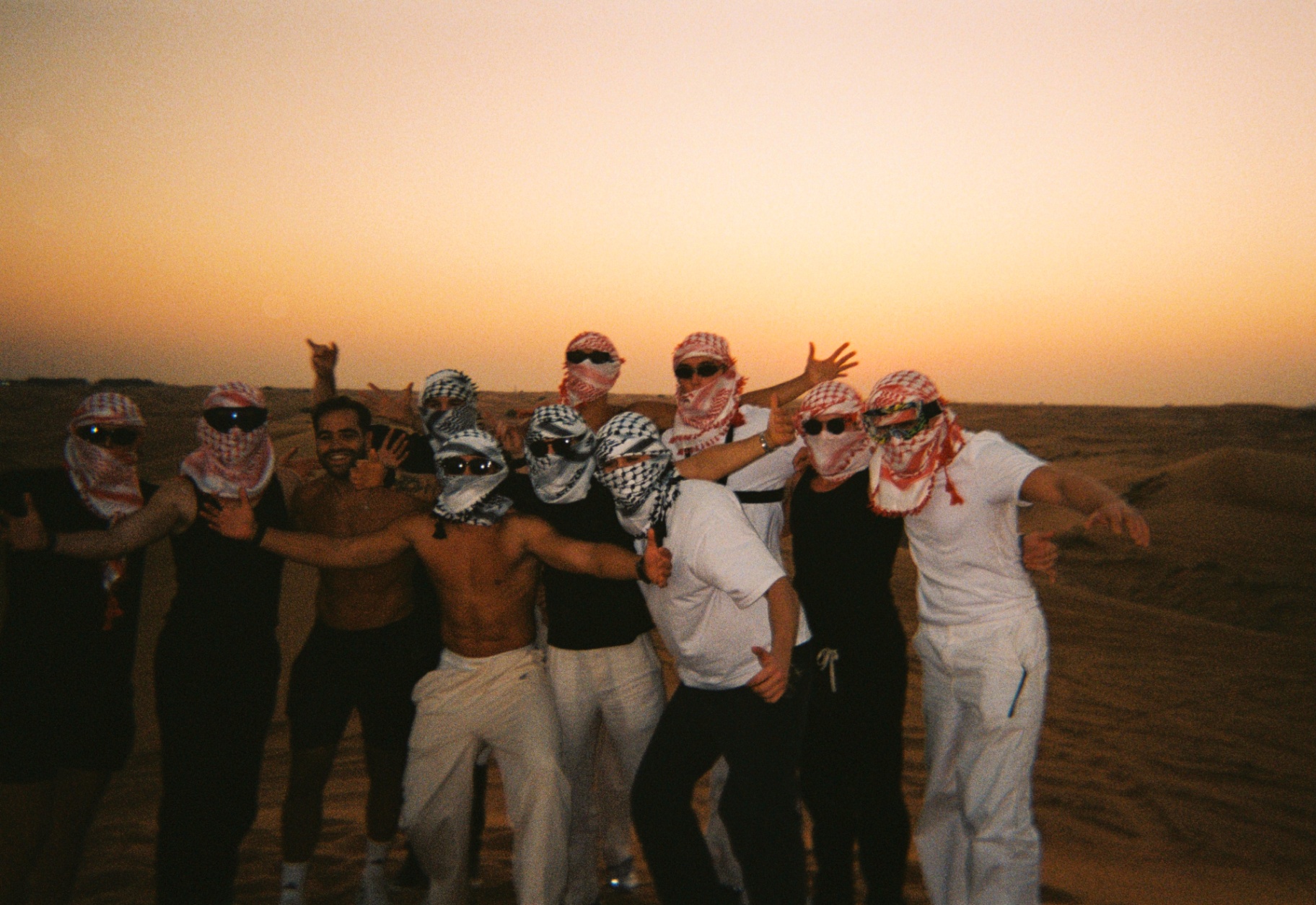 Members celebrating a desert experience at sunset